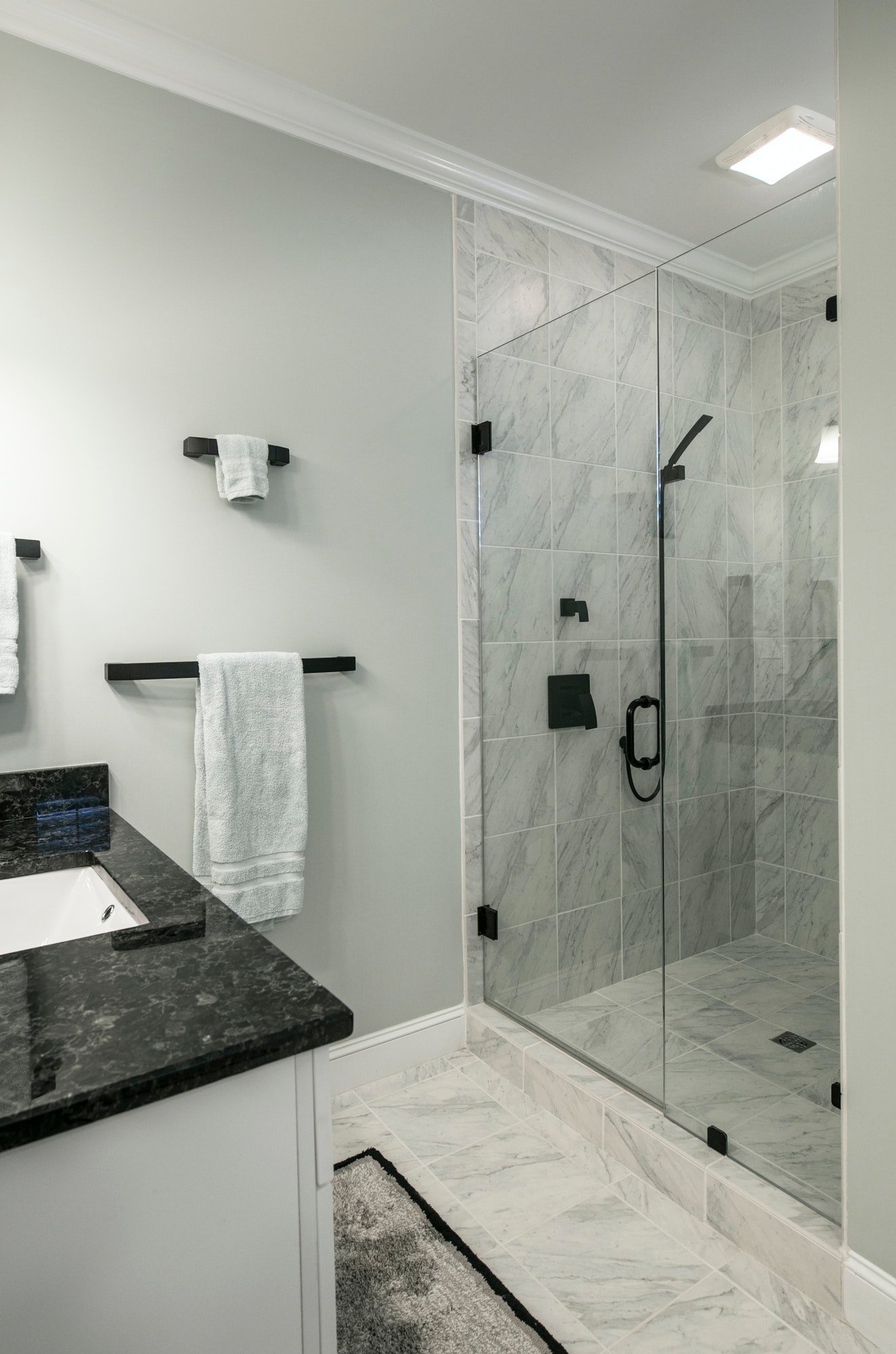 Modern bathroom with glass shower and marble tile.